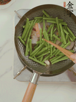 下掰好的缸豆段翻炒，略燜煮。